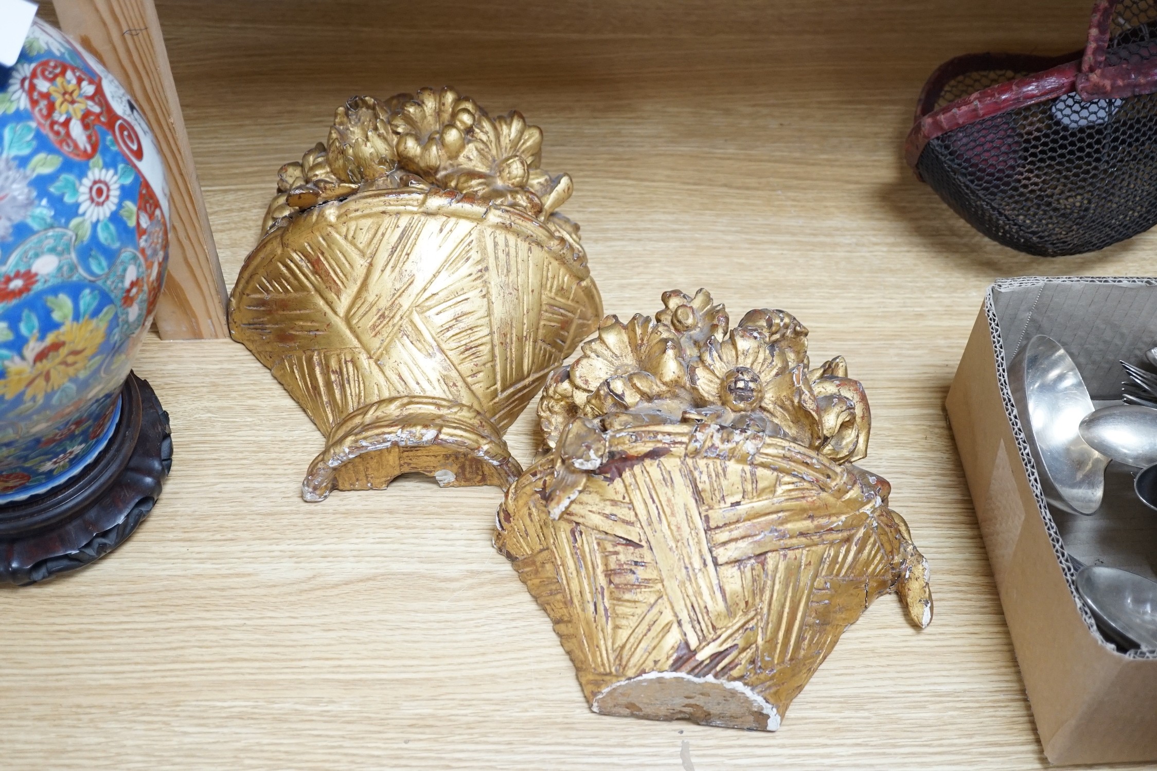 A pair of carved giltwood basket wall sconces, 29cms high
